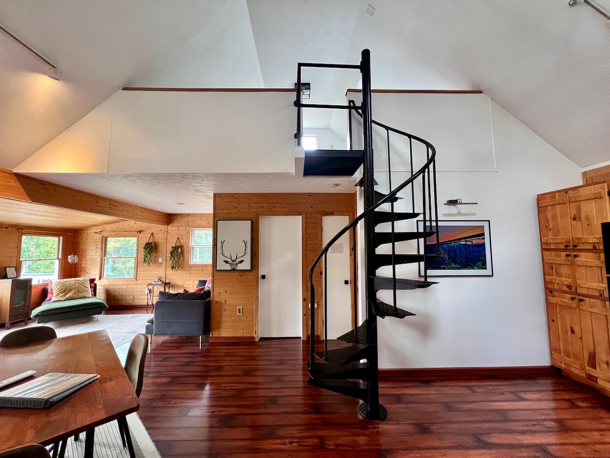 Open plan living with spiral staircase